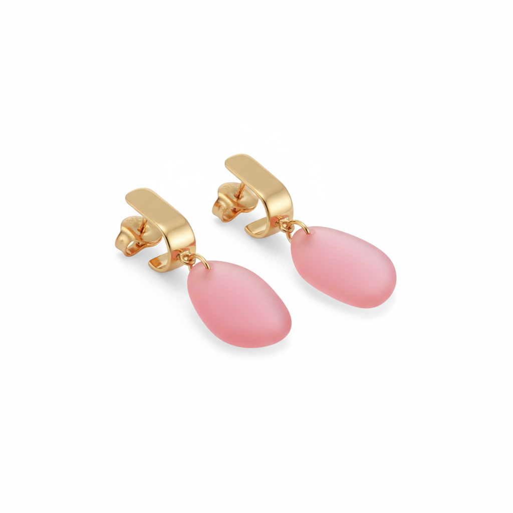 Gold earrings with pink teardrop-shaped stones on a white background