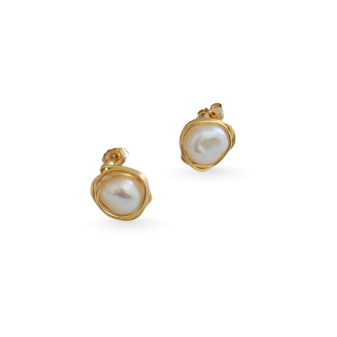 Pair of gold earrings with pearl-like stones on a white background