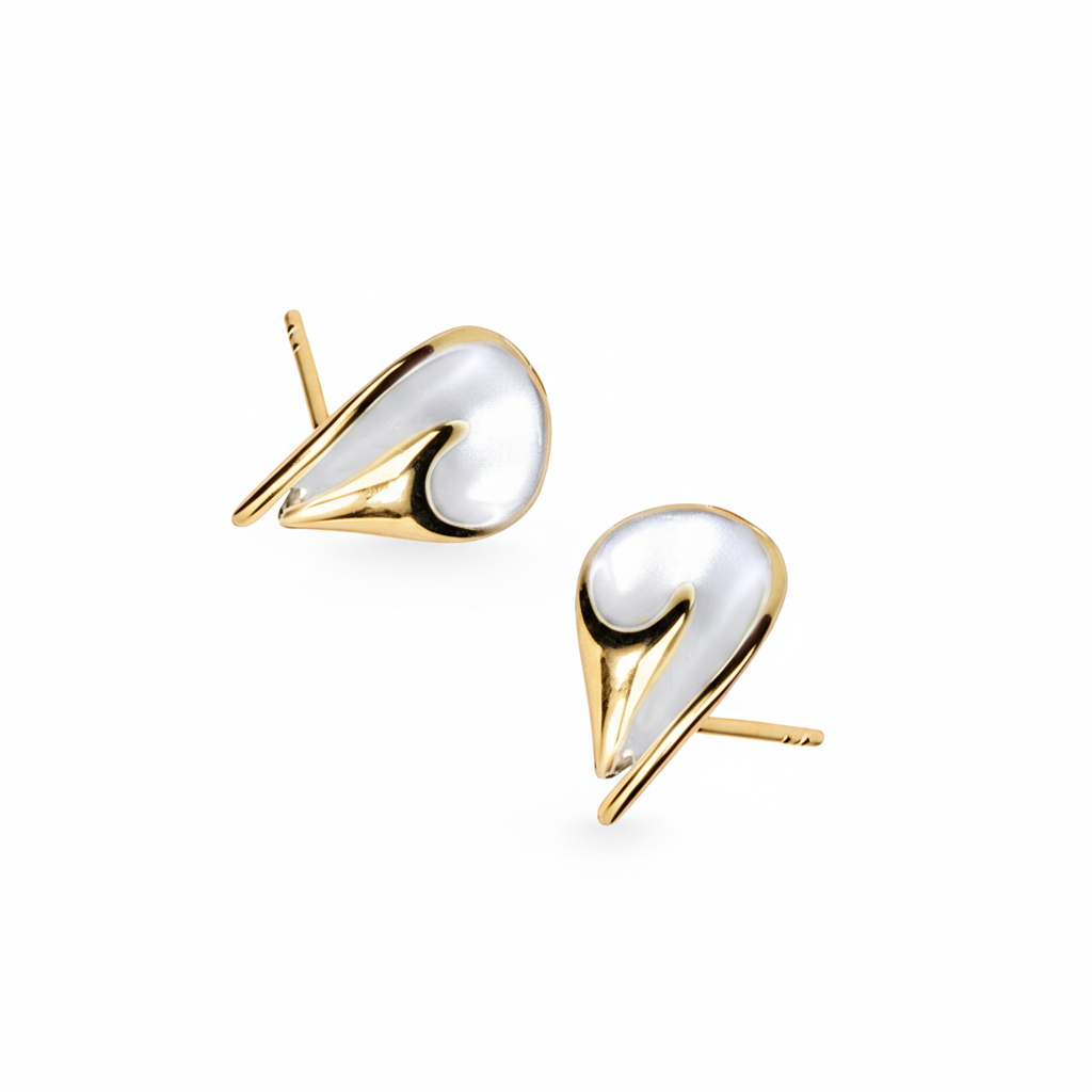 Gold and white earrings on a white background