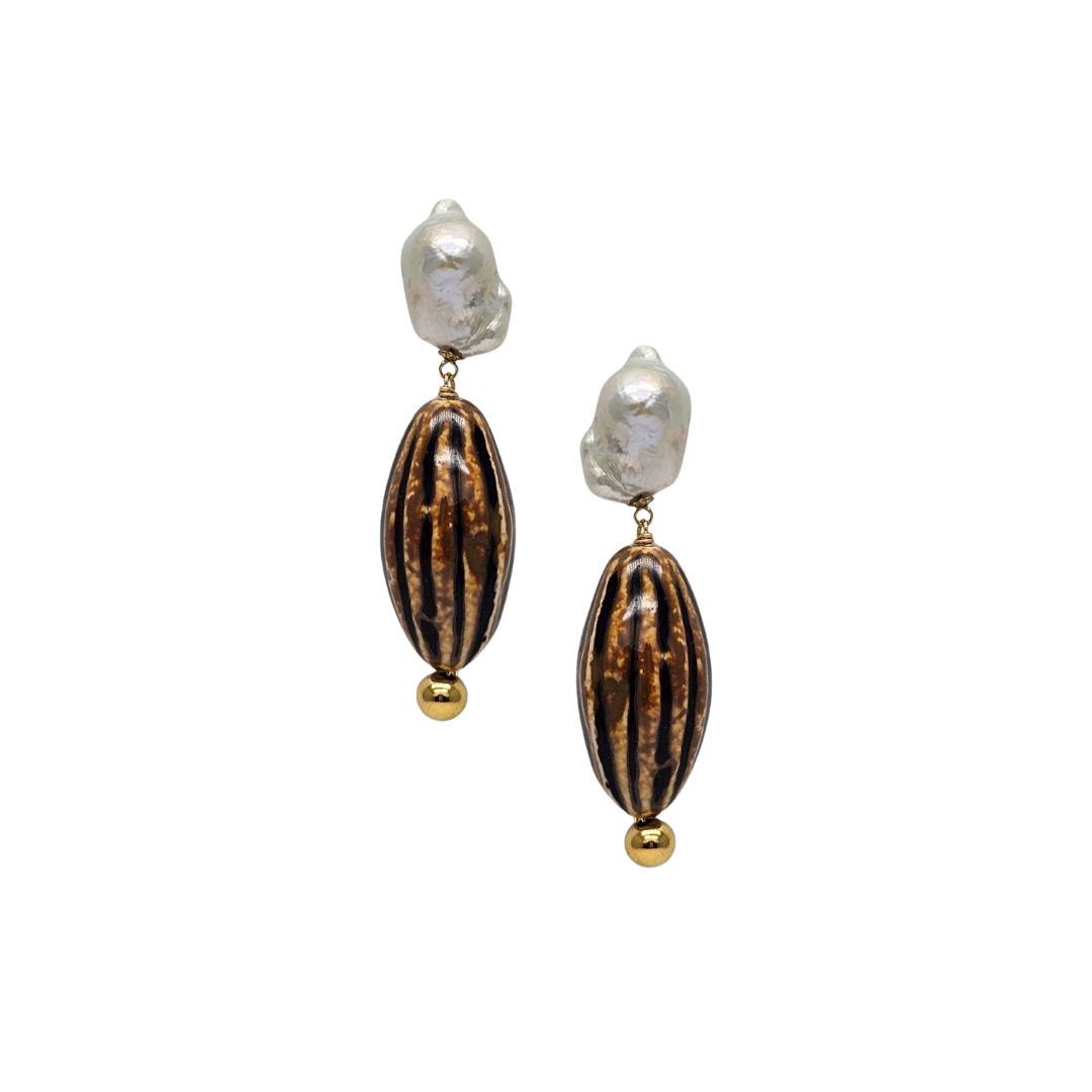 Pair of earrings with brown oval beads and gold accents on a white background