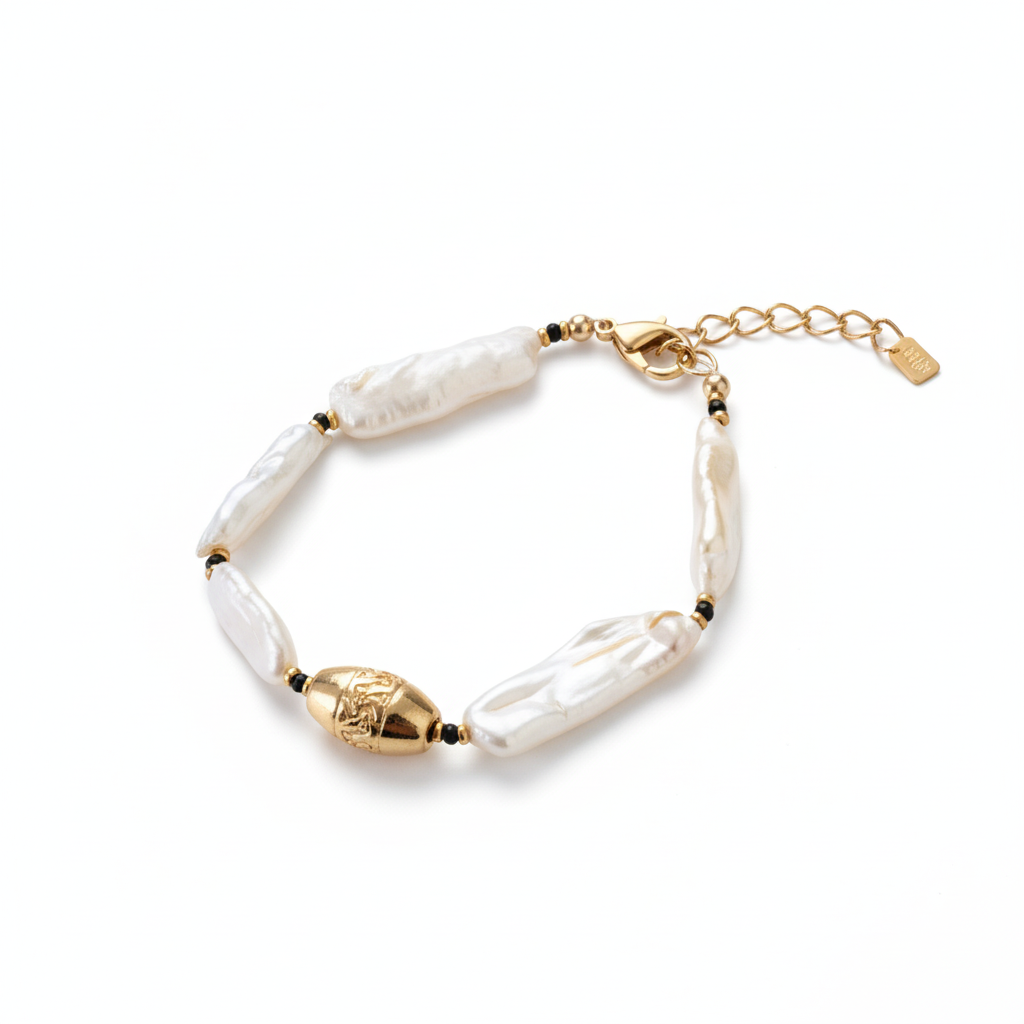 Pearl bracelet with gold accents on a white background