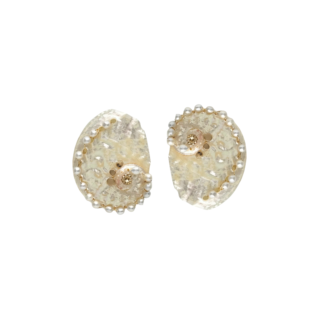 Pair of gold and clear crystal earrings on a white background