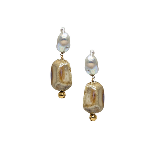Pair of earrings with gold and pearl-like beads on a white background