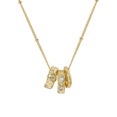 Gold necklace with three interlocking rings on a white background