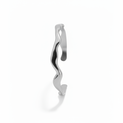 Silver bracelet with wavy design on a white background