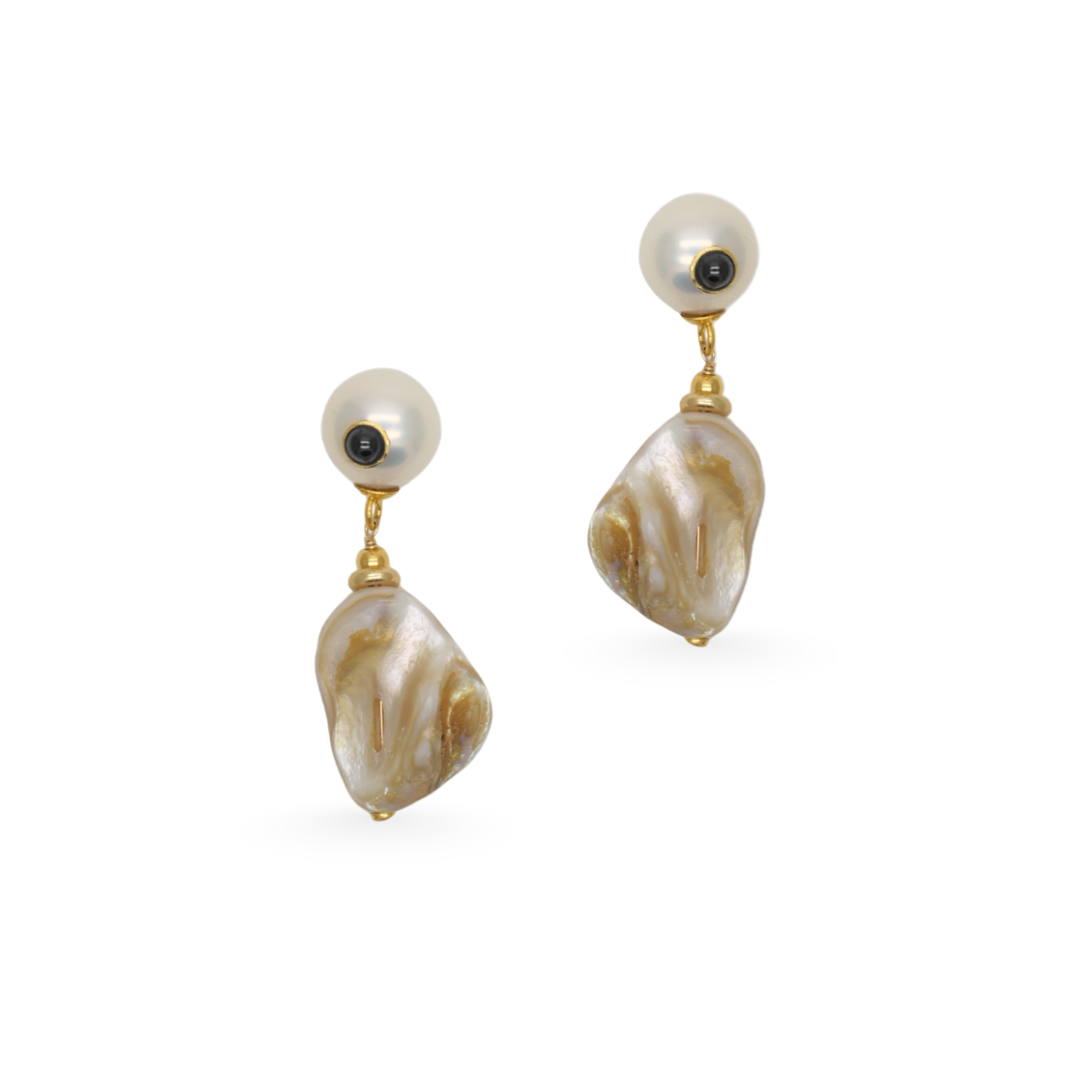 Pair of pearl earrings with gold accents on a white background