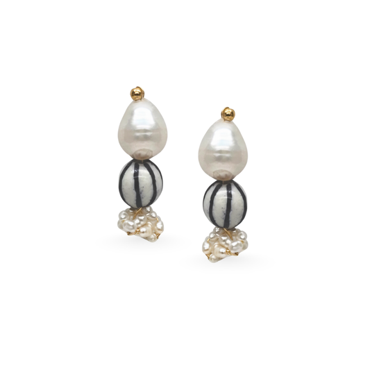 Pair of earrings with pearls and striped beads on a white background