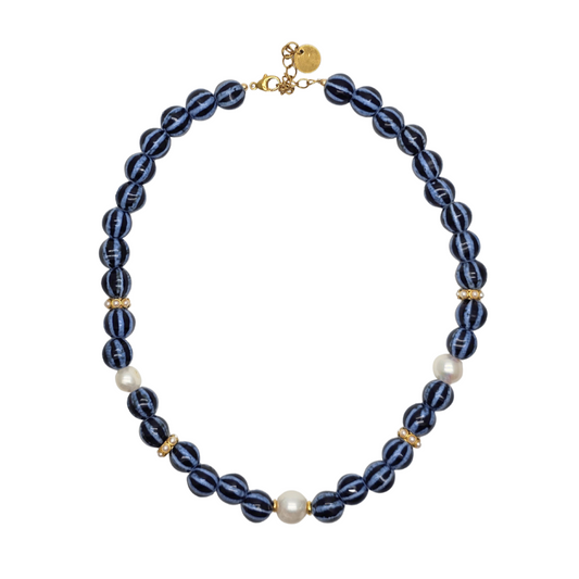 Necklace with blue beads and gold accents on a white background