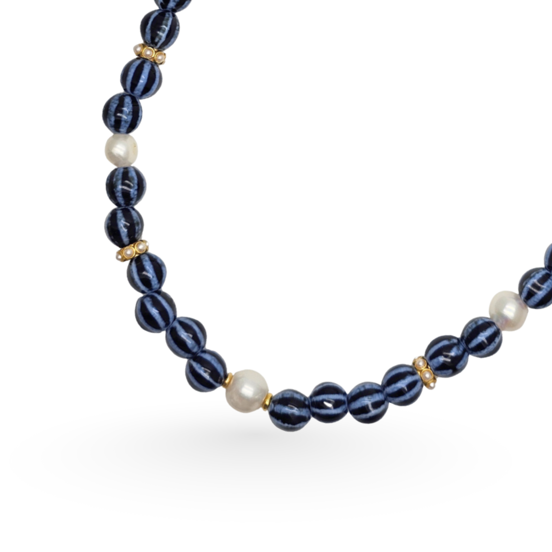 Necklace with blue beads and pearls on a white background
