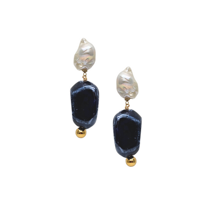 Pair of earrings with dark blue beads and gold accents on a white background