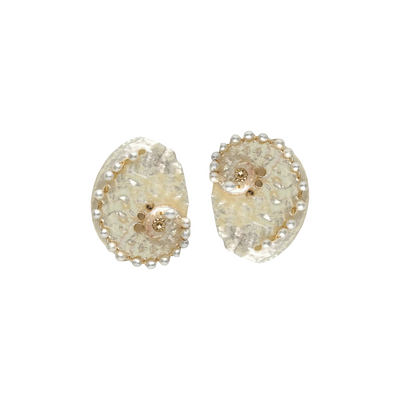 Pair of gold and clear crystal earrings on a white background